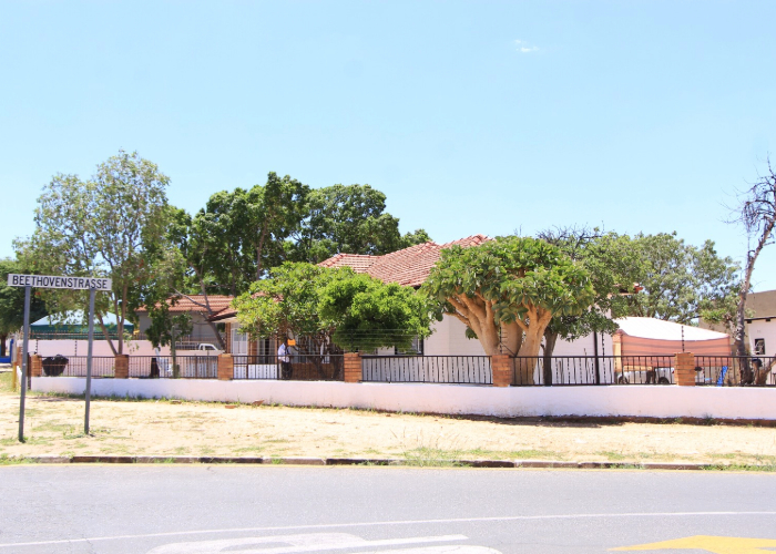 Tenebix campus exterior with leafy trees and a red tiled roof